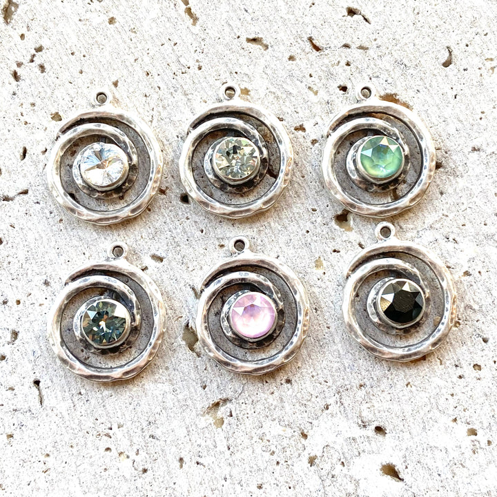 a group of metal buttons sitting on top of a cement floor