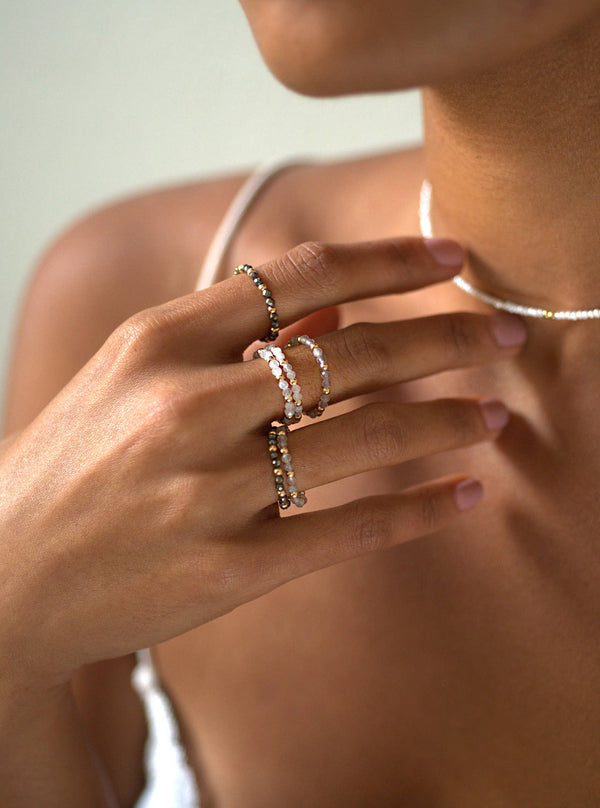 a woman's hand with three rings on it