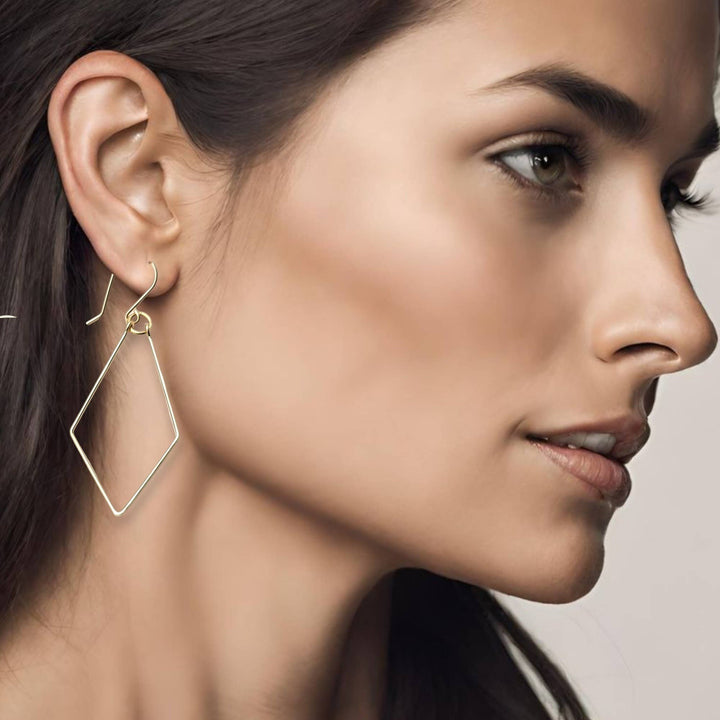 a close up of a woman wearing a pair of earrings