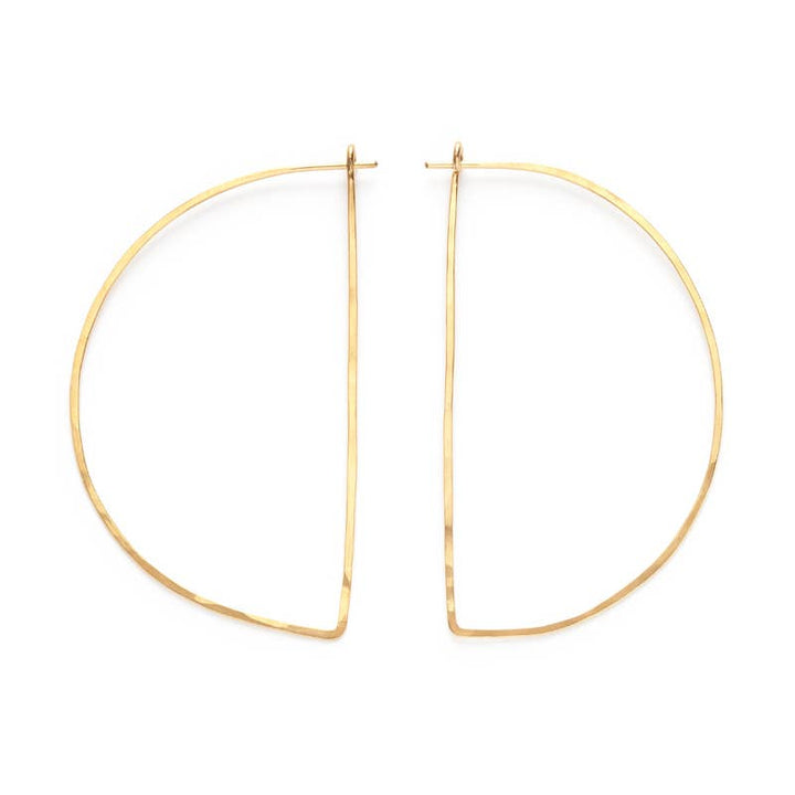 a pair of gold hoop earrings on a white background