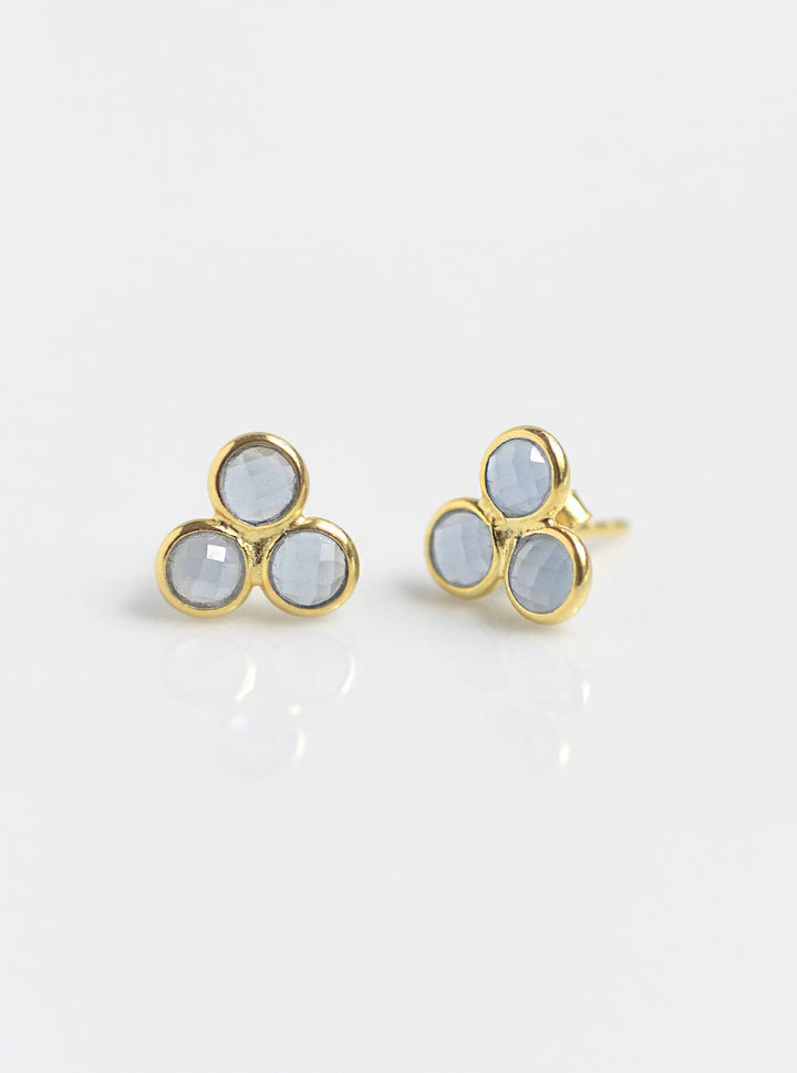 a pair of gold and white earrings