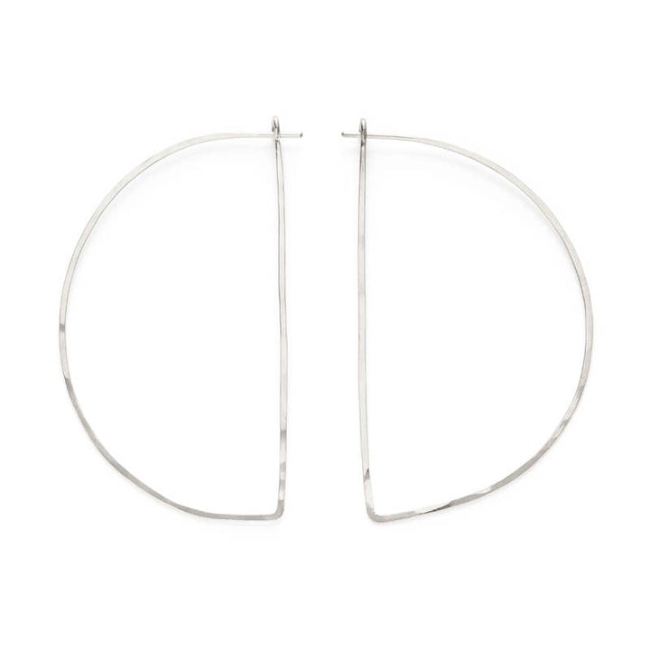 a pair of silver hoop earrings on a white background