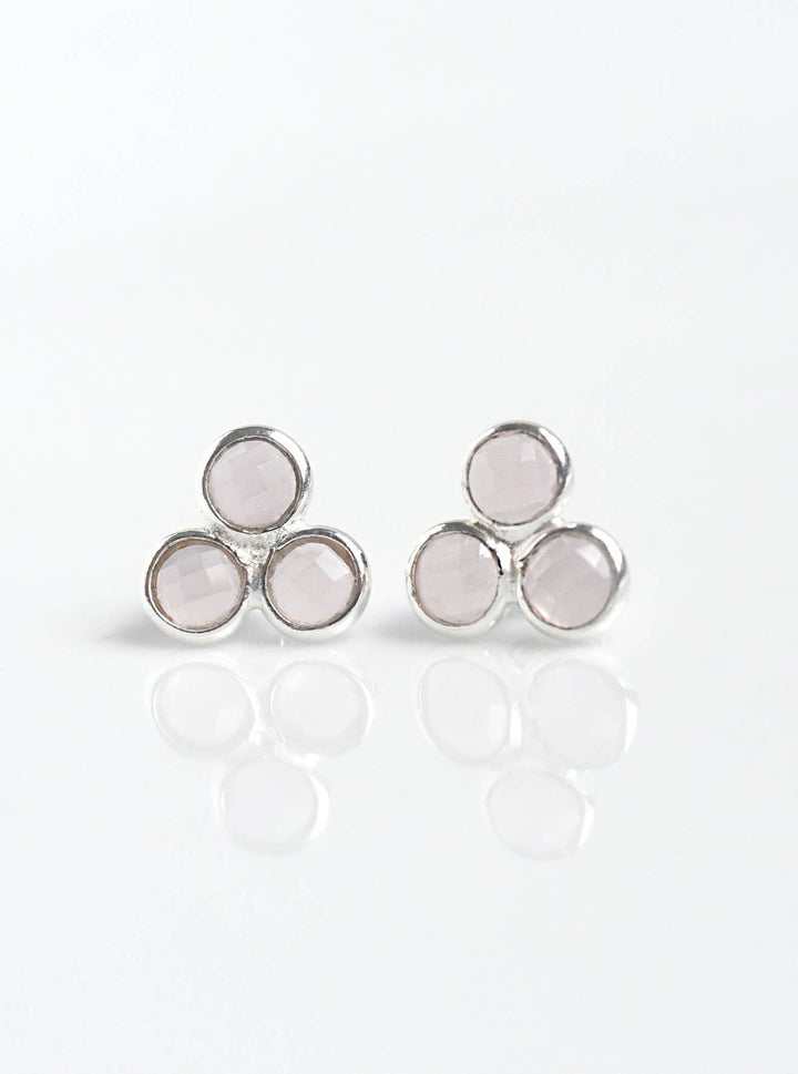 a pair of earrings on a white background