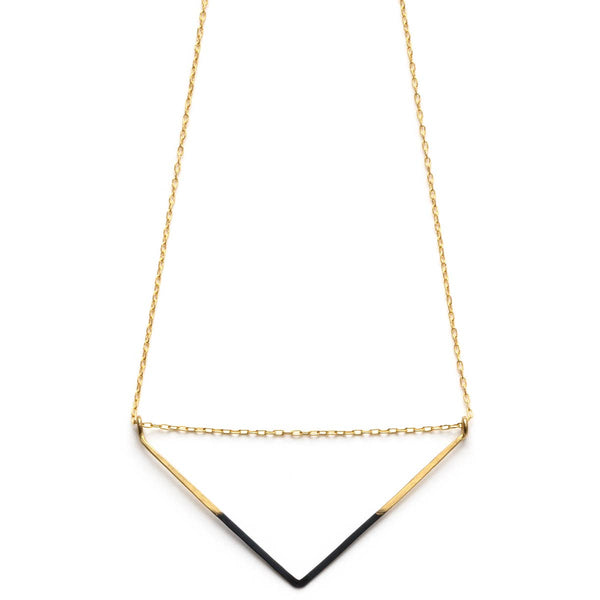 a black and gold necklace on a white background