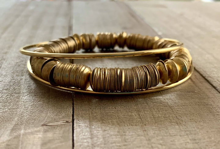 a close up of a bracelet on a wooden surface