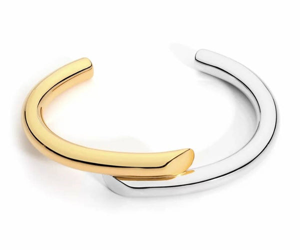 a pair of gold and silver bracelets on a white background