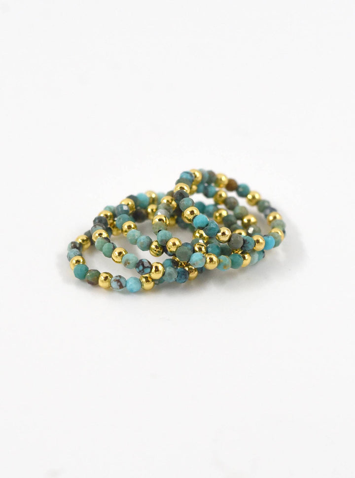 three bracelets with gold and turquoise beads