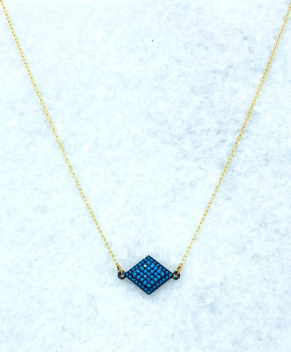 a necklace with a blue diamond on it