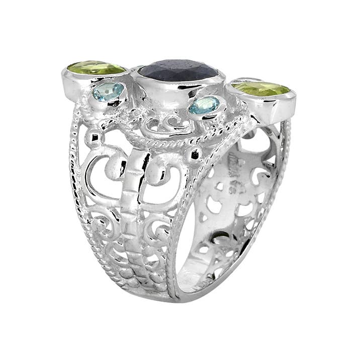 a silver ring with two green stones on it