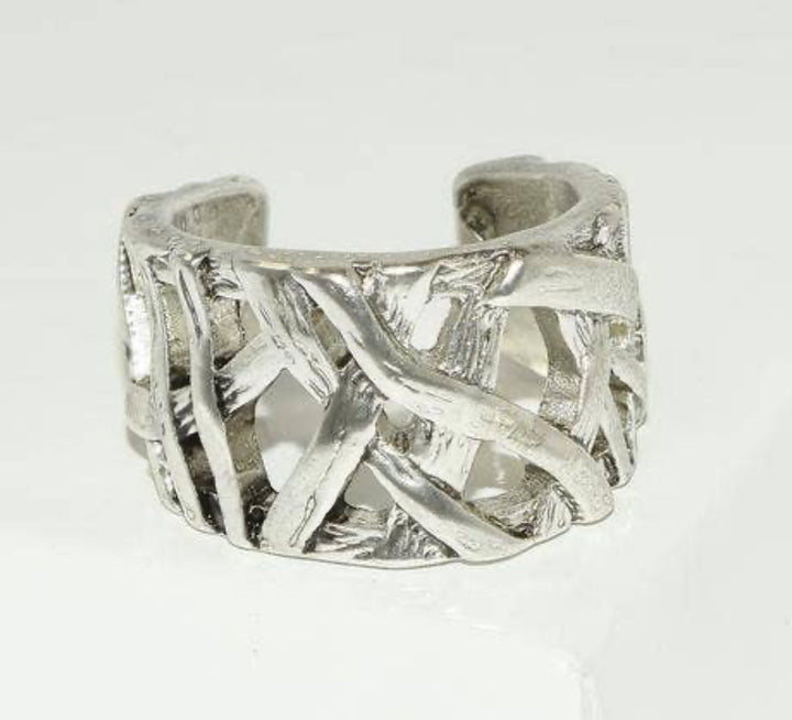 a close up of a silver ring on a white background