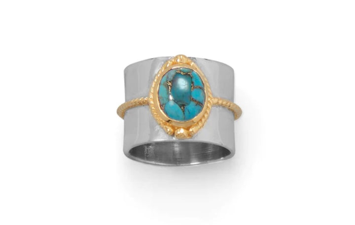 a silver and gold ring with a turquoise stone