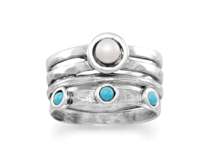 a stack of silver rings with turquoise stones