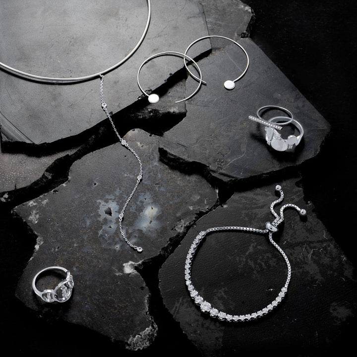 a black and white photo of jewelry on a rock