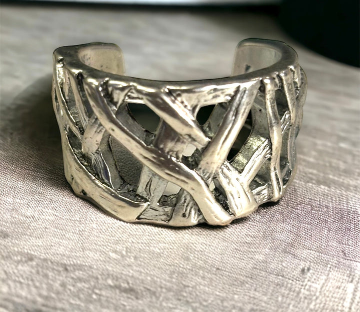 a silver ring sitting on top of a table