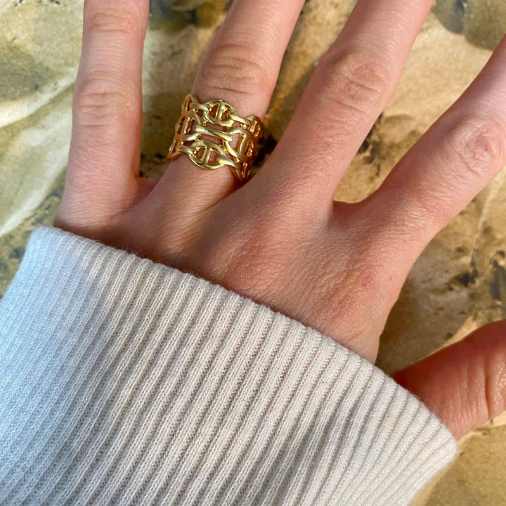 a woman's hand with a gold ring on it