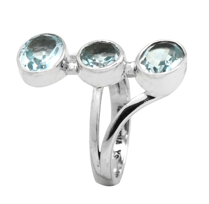 a silver ring with three blue stones on it