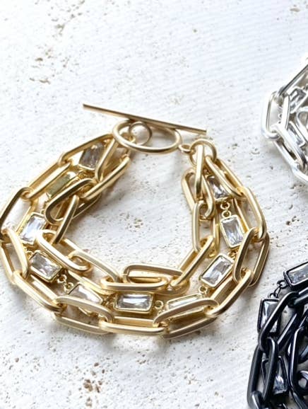 a pair of gold, silver and black bracelets