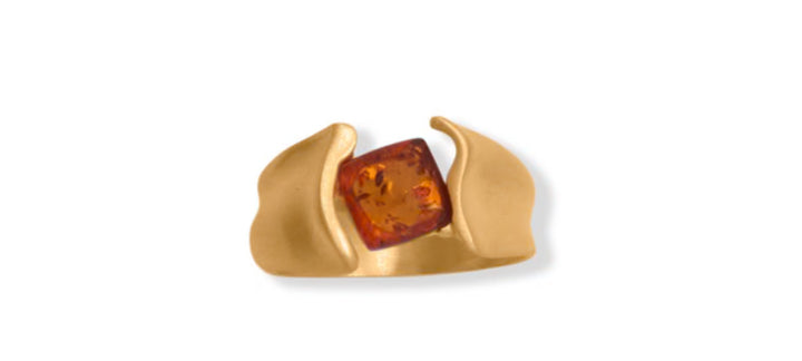 a gold ring with an orange stone in it