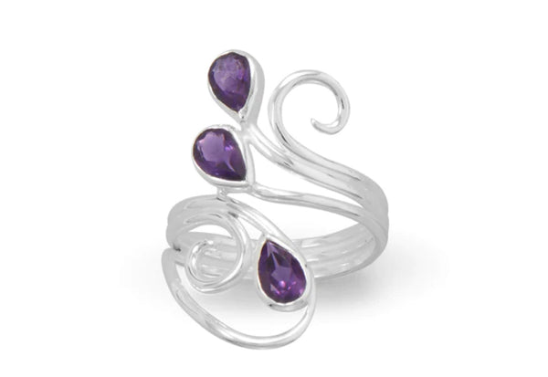 a silver ring with purple stones on it