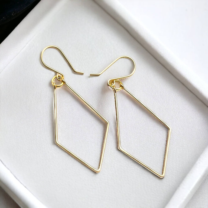 a pair of earrings sitting on top of a white tray