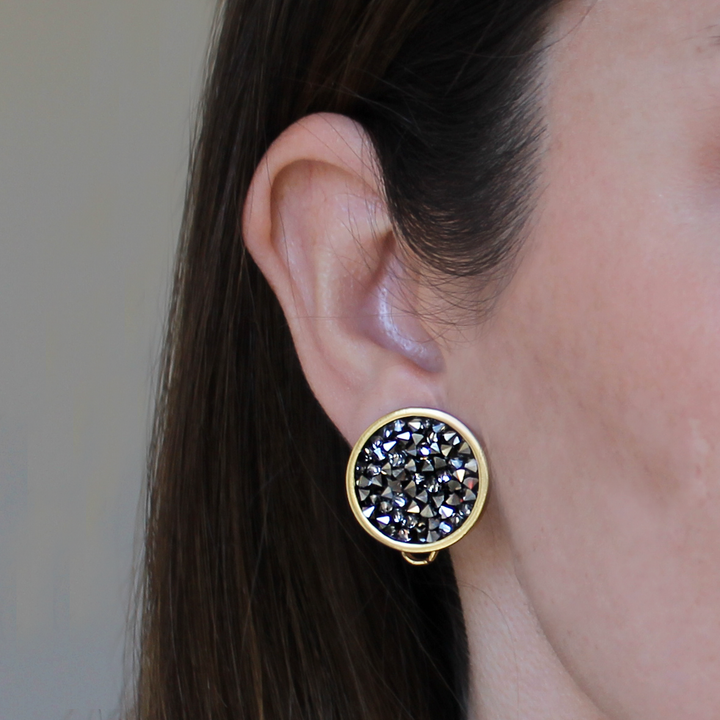 a close up of a person wearing a pair of earrings