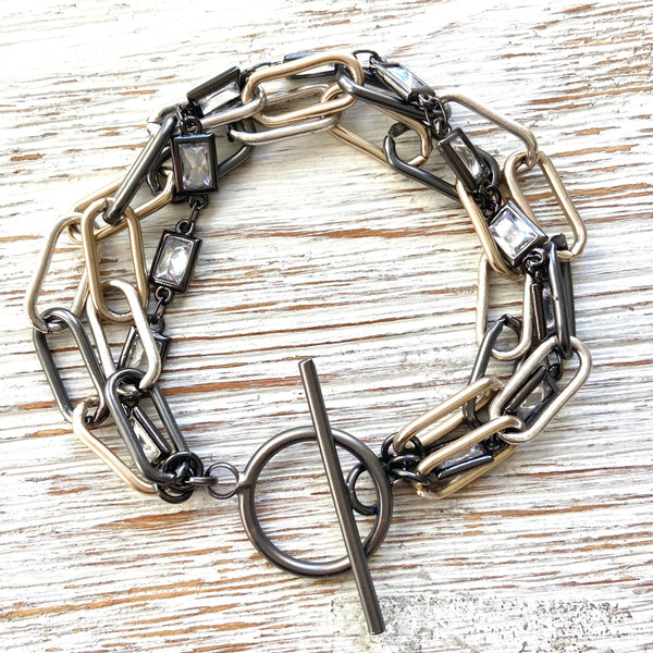 a chain bracelet with a metal clasp and a circle clasp