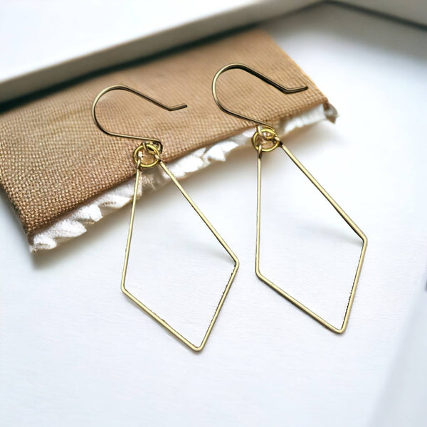 a pair of earrings sitting on top of a table