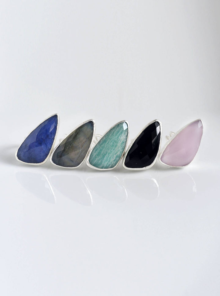 a row of different colored stones sitting on top of a white surface