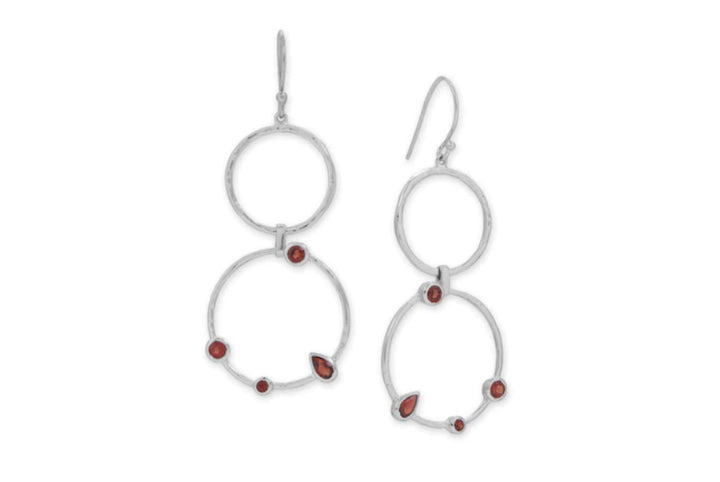 a pair of silver hoop earrings with red stones