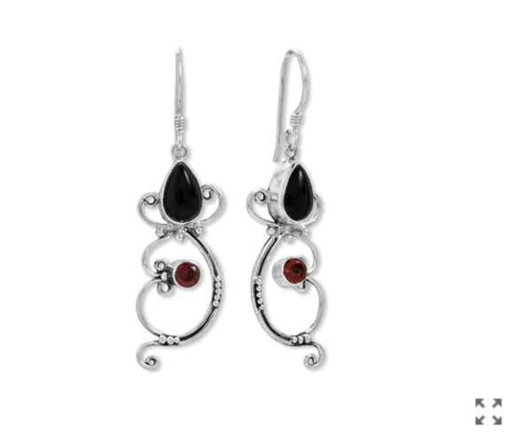 a pair of earrings with garnets on them